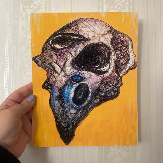 Artistic depiction of a bird skull on a yellow background held by a hand.